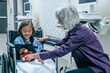 © FS Productions/Blend Images - Doctor giving teddy bear to girl in wheelchair