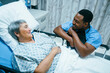 © FS Productions/Blend Images - Nurse talking to patient in hospital bed