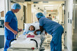 © FS Productions/Blend Images - Nurses talking to girl in hospital gurney