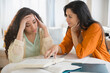 © JGI/Jamie Grill/Blend Images - Mother helping daughter with homework