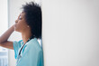 © JGI/Jamie Grill/Blend Images - African American nurse leaning against wall