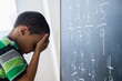 © JGI/Jamie Grill/Blend Images - Mixed race boy doing math problems at board in class