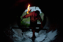 Mari Man Holding Torch In Tunnel