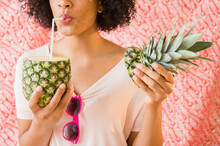 Woman Drinking Juice From Fresh Pineapple