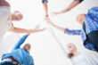 © JGI/Jamie Grill/Blend Images - Close up of teenagers cheering with arms outstretched in huddle