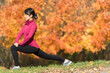 © JGI/Tom Grill/Blend Images - Asian runner stretching in park
