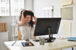 © JGI/Tom Grill/Blend Images - Mixed race businesswoman frustrated at computer at desk in office