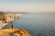 © Adam Hester/Blend Images - Caucasian couple on cliff admiring seascape