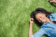 © JGI/Jamie Grill/Blend Images - Black woman laying in grass