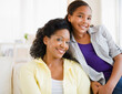 © JGI/Jamie Grill/Blend Images - Mother and daughter smiling in living room