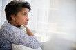 © JGI/Jamie Grill/Blend Images - Pensive older Black woman clutching pillow