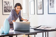 © JGI/Tom Grill/Blend Images - Black businesswoman using laptop in art gallery office