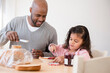 © JGI/Jamie Grill/Blend Images - Father and daughter making sandwiches