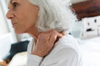 © JGI/Jamie Grill/Blend Images - Older woman rubbing the neck