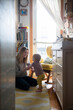 © JGI/Jamie Grill/Blend Images - Smiling mother helping baby son walking