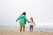 © Adam Hester/Blend Images - Caucasian mother and daughter holding hands on beach