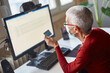 © Teodor Lazarev - Elderly woman checking her bank account