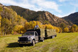 © Kelly/Tetra Images - Rancher with bales of hay on his truck