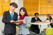 © shine - Two young asian students campus helps friend catching up and learning tutoring...