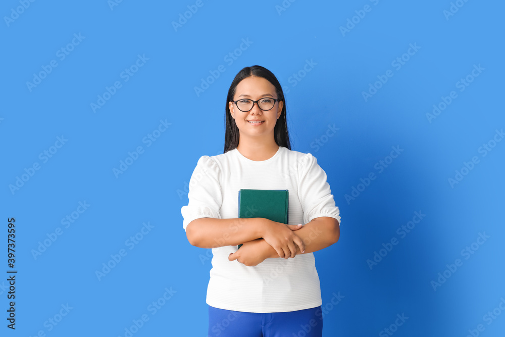 Asian female teacher on color background