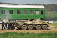 Soldiers Of The Special Forces Unit Are Moving To The Assault Under The Cover Of An Armored Personnel Carrier
