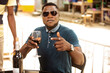 © vystekimages - young man holding a glass of red wine