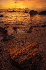 Wall Mural - The rock on the sea with sunset sky