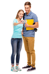 Youth and technology. Young attractive students couple taking selfie on smartphone together. Isolated on white.