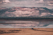 Views of mountain peaks and the city of Syracuse from Antelope Island State Park in Utah, USA. Water reflections, traveling road, Great Salt Lake. 