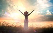 International Women's Day Concept: Silhouette Of Healthy Woman Raised Hands For Praise And Worship God At Autumn Sunset Meadow Background