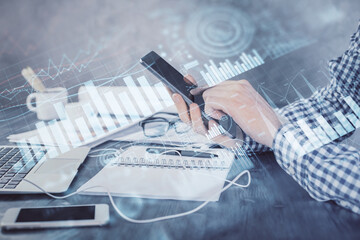 Aufkleber - Double exposure of man's hands holding and using a digital device and forex graph drawing. Financial market concept.