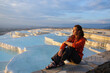 A woman watches the sunset from the parapet in Pamukkale. Turkey