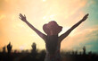 © Choat - Praise and worship God concept: Silhouette woman raised hands over autumn sunset background