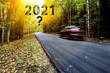 Road with car traveling to year 2021 with sunlight and question mark