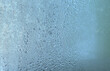 © Aleksandr - The texture of frozen drops of condensation on a transparent glass window. Water drops. Rain. Abstract texture background. A sharp cold snap, a frozen drop of water on the glass in winter