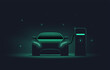 © paul_craft - Electric car at charging station. Front view electric car silhouette with green glowing on dark background. EV concept. Vector illustration