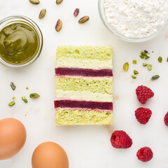 Wall Mural - Slice of pistachio and raspberry cake. Top view. Slice filling in section on a marble dek.