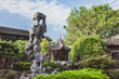 Giant rock in garden by Chinese architecture at Lingering Garden Scenic Area, Suzhou, Jiangsu, China