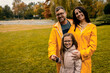 © Zoran Zeremski - Family of three in raincoat enjoying together in city park after rain.
