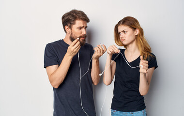 young couple in headphones listening to music fun friendship emotions