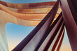 © okrasiuk - Futuristic urban architecture. Art arch vertical triangles made of brown tin metal with a blue sky background. Abstract backdrop. Selective focus. Copy space.