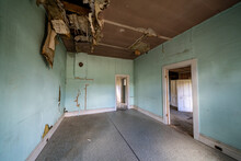 The Rotting And Decaying Interior Of An Old Kitchen In An Abandoned Home In Bannack Ghost Town. Ceiling Is Collapsing