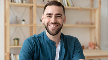 Wall Mural - Banner panoramic view of smiling Caucasian male employee have video call or webcam digital virtual conference at workplace. Headshot portrait of happy businessman at workplace. Employment concept.