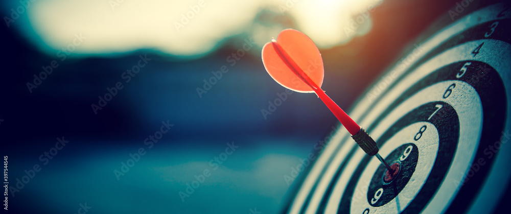 bullseye target or dart board has red dart arrow throw hitting the center of a shooting for business targeting and winning goals business concepts. - obrazy, fototapety, plakaty 