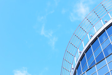 Architectural detail of the facade with multiple reflections of other buildings and the sun. Modern building. Architecture background