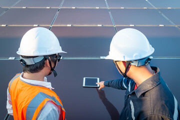 Engineers with investor check the operation of the solar farm(solar panel) systems, Alternative energy to conserve the world is energy, Photovoltaic module idea for clean energy production