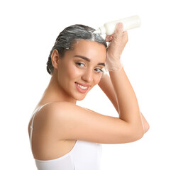 Wall Mural - Young woman applying dye on hairs against white background