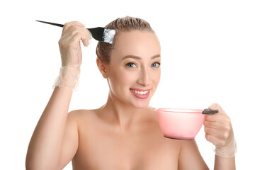 Canvas Print - Young woman applying dye on hairs against white background