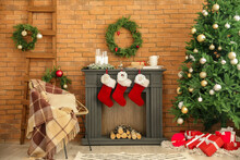 Interior Of Living Room With Fireplace Decorated For Christmas