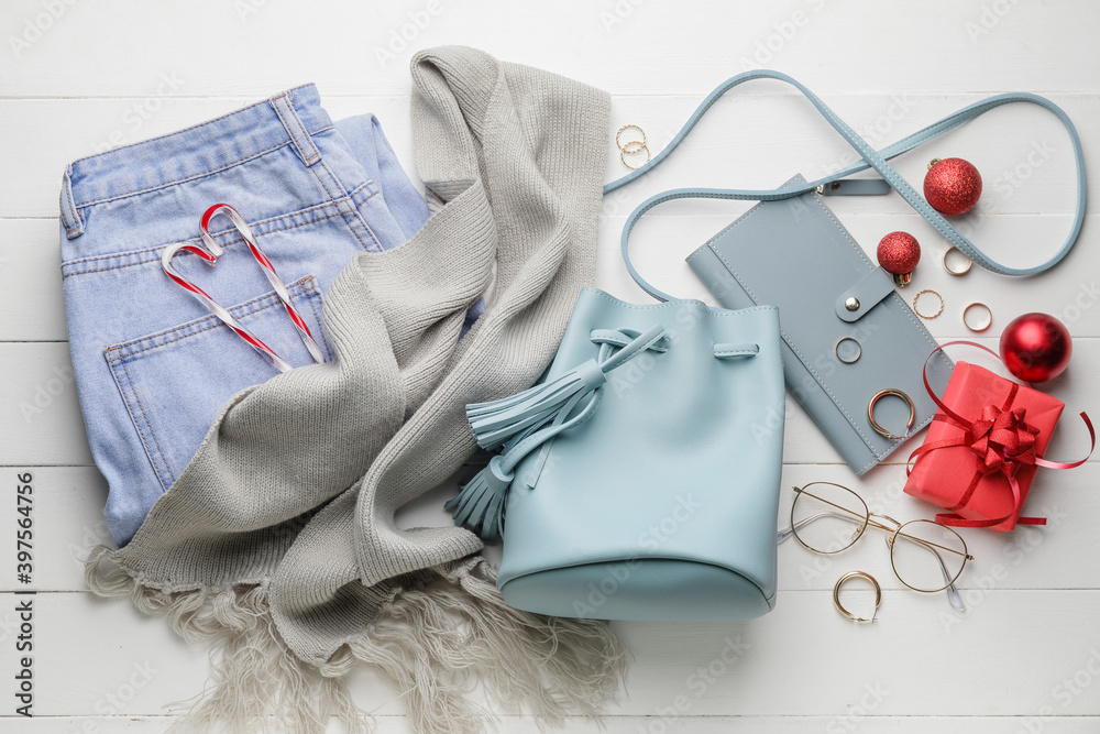 Christmas composition with stylish clothes and accessories on white wooden background